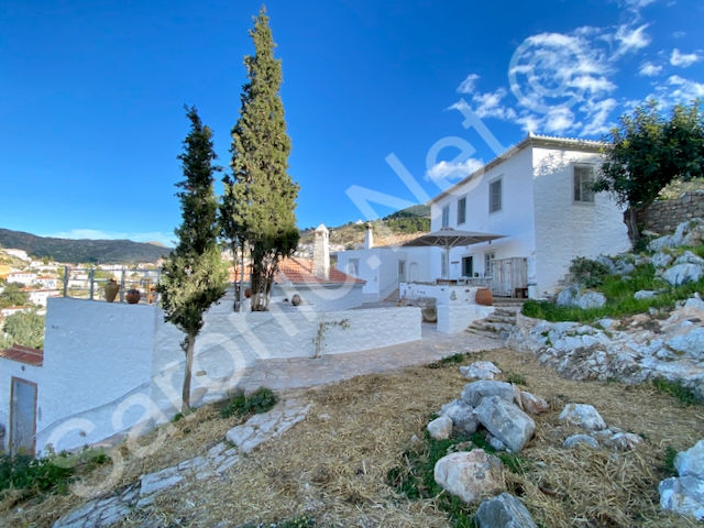 Typical handsome Hydriot stone property with grey shuttered windows and terraces with far reaching views