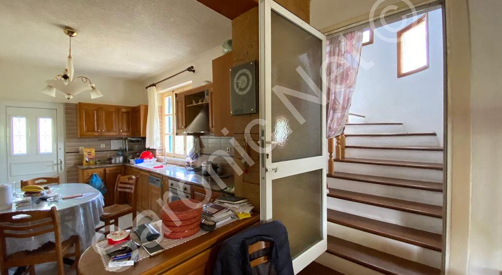 A breakfast bar separates the kitchen area and a nice wide staircase lead to the upper floor from here