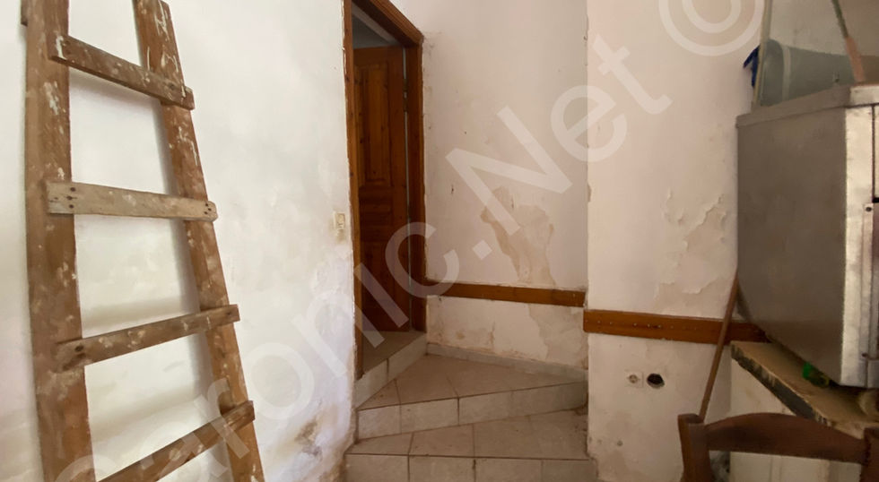 Vestibule, steps up to doorway of small corridor.