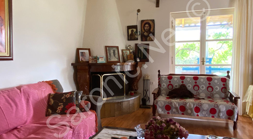 Bright sitting area looking out to the garden through patio doors. Usable fire and chimney
