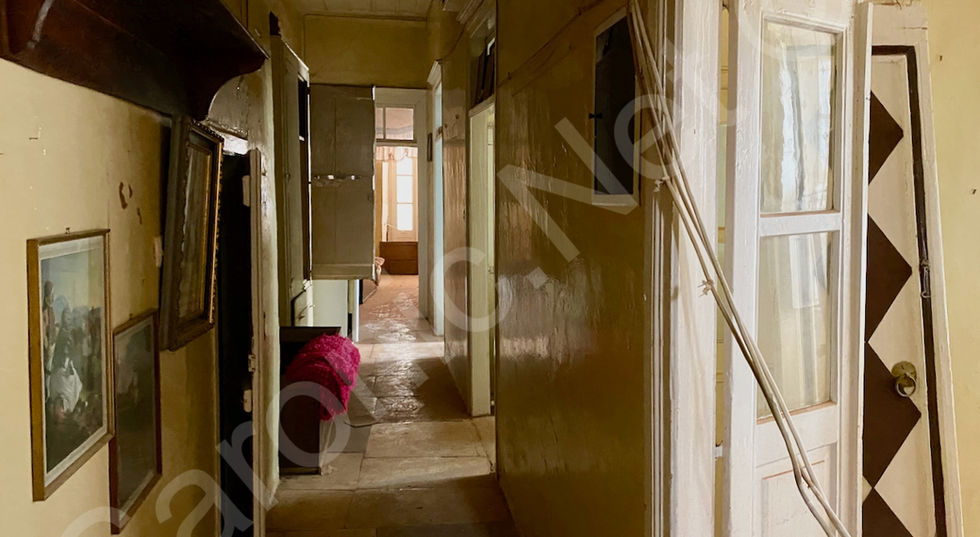 long flag floored hallway with stairs to roof on left (WC under) and three (bed)rooms along the right.