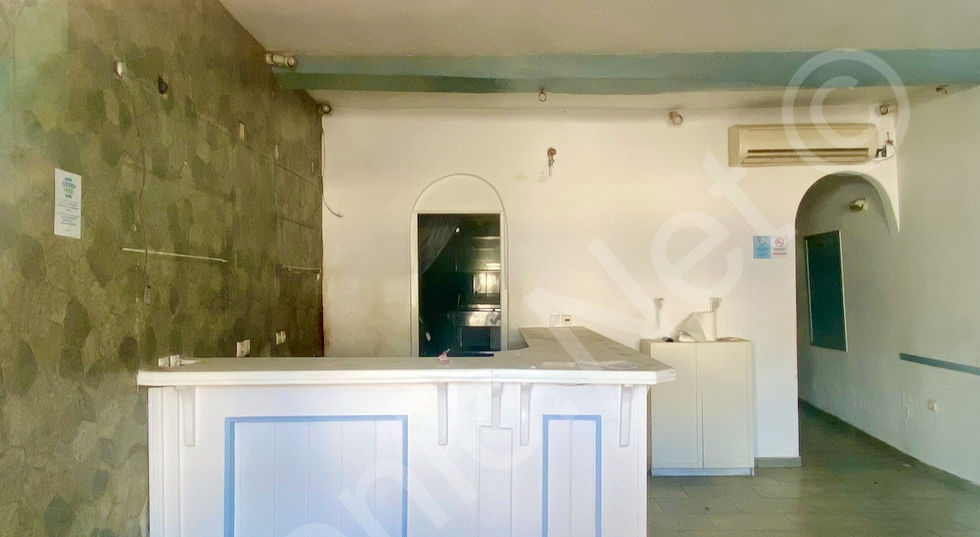 ground level shop interior kitchen behind reception desk, WCs through arch