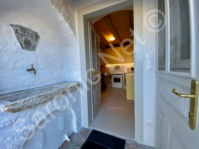 Entrance doorway with handy stone shelved nook and useful outside tap looking through to kitchen