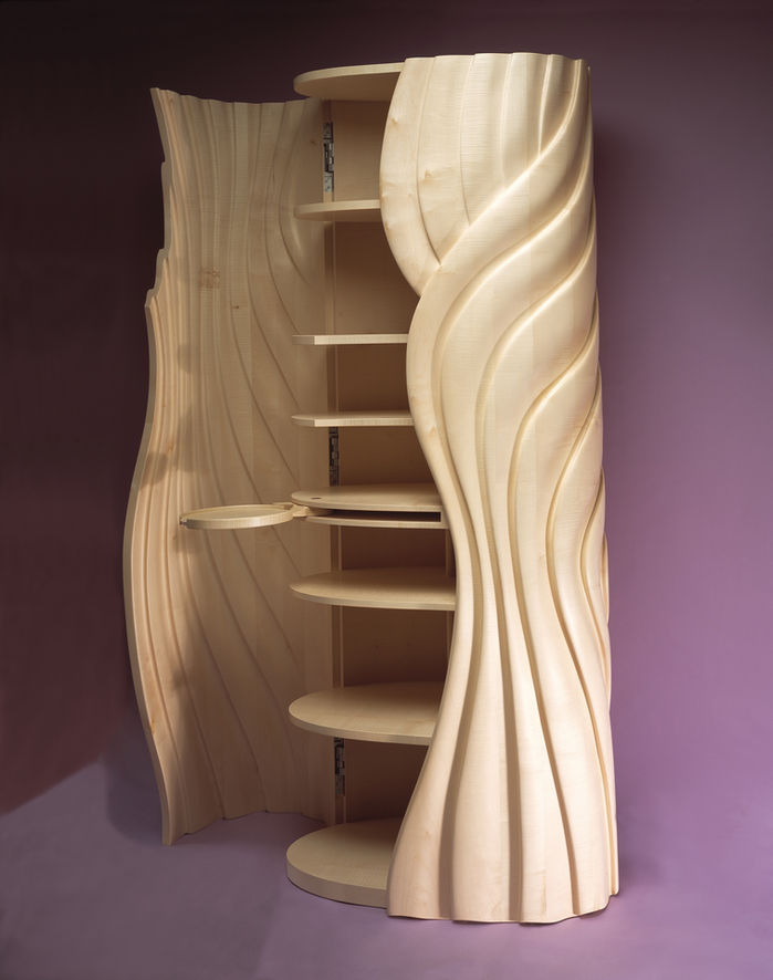 A bespoke cabinet by John Makepeace with doors open exposing shelves