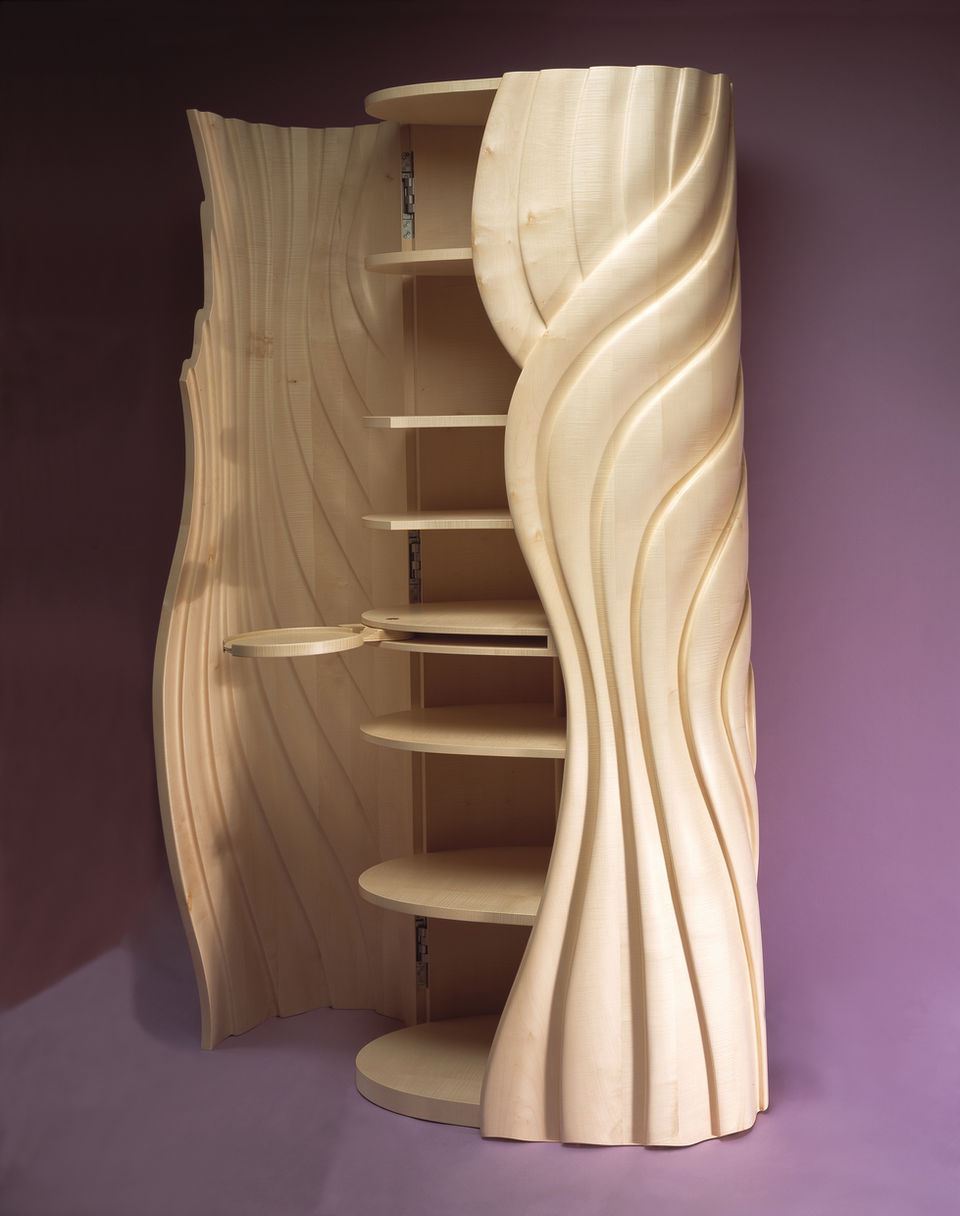 A bespoke cabinet by John Makepeace with doors open exposing shelves