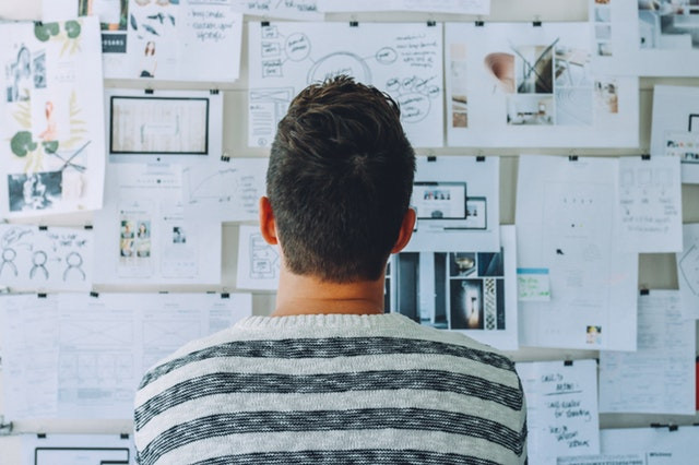 Man staring at exercise lists