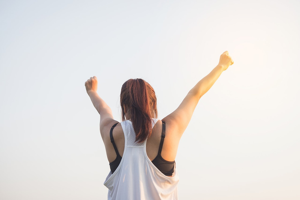 Triumphant Mom reaching to sky