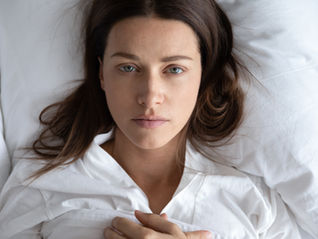 woman laying down anxious
