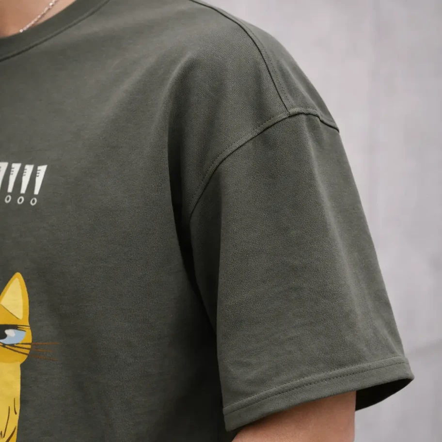 Shoulder close up shot of person wearing olive green t-shirt 