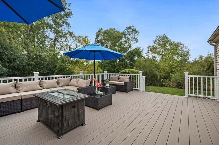 TimberTech Terrain Sandy Birch composite deck with seating and white railing built by OnDeck in Libertyville IL