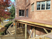 Exposed deck framing showing joists, beams, and posts