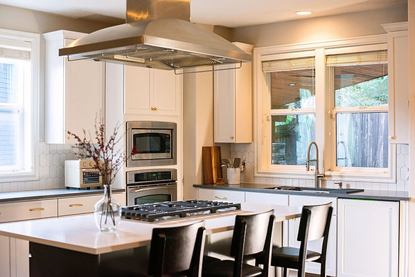 Modern kitchen with white refaced cabinets and island.