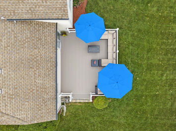 Close-up of TimberTech Terrain Sandy Birch decking corner with white composite railing built by OnDeck in Libertyville