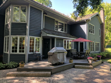 Silver Maple TimberTech porch design with two steps to patio constructed by OnDeck Outdoor Space Builder