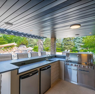 Dry under-deck patio space with drainage system installed
