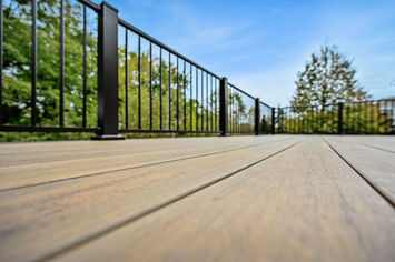 Wide view of second-level TimberTech Legacy Tigerwood deck with Mocha stairs and Kona railing built by OnDeck