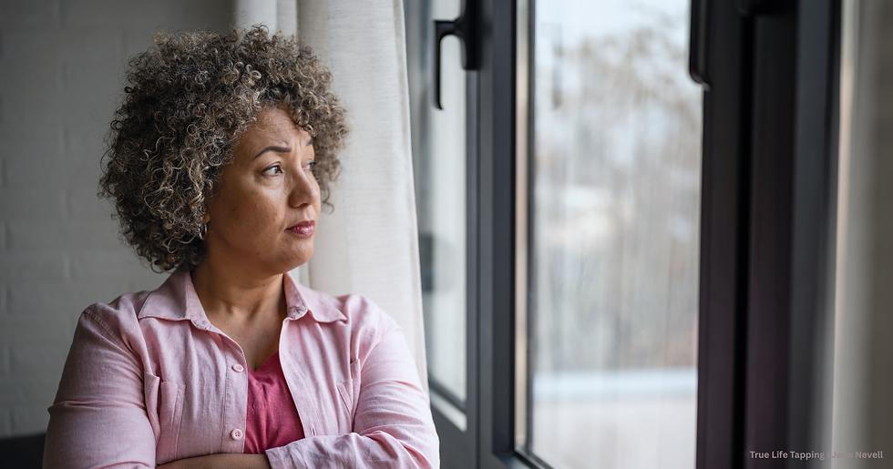 Woman looking out of a window reflecting on self-discovery after years of people-pleasing.