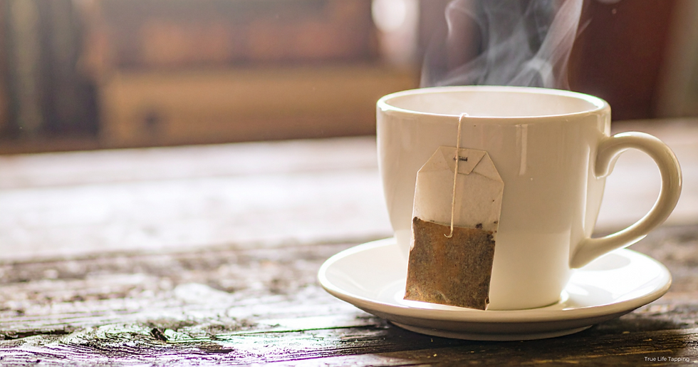 A steaming cup of tea on a wooden table, creating a quiet moment for reflection.