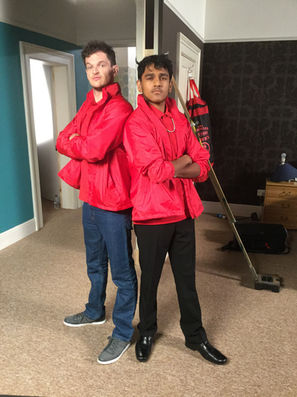 Ryan and Omar in pizza delivery uniforms