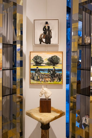Framed paintings on a mirrored gallery wall at a curatorial exhibition by Astrid Burns Art Consulting