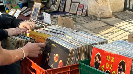 A woman going through records at a carboot sale listed on Ganddee