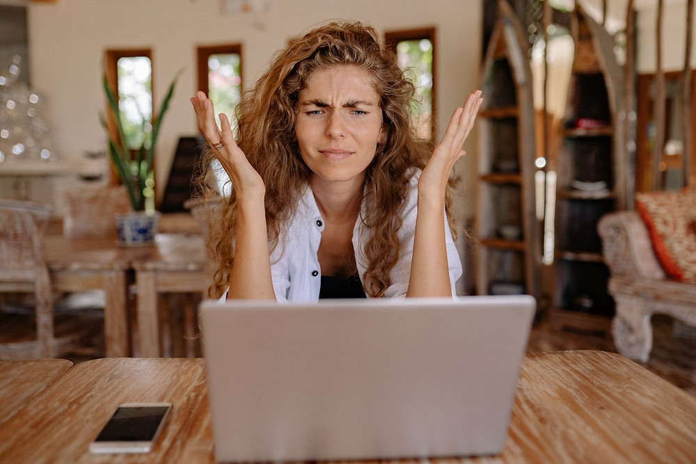 Frustrated women looking at her laptop