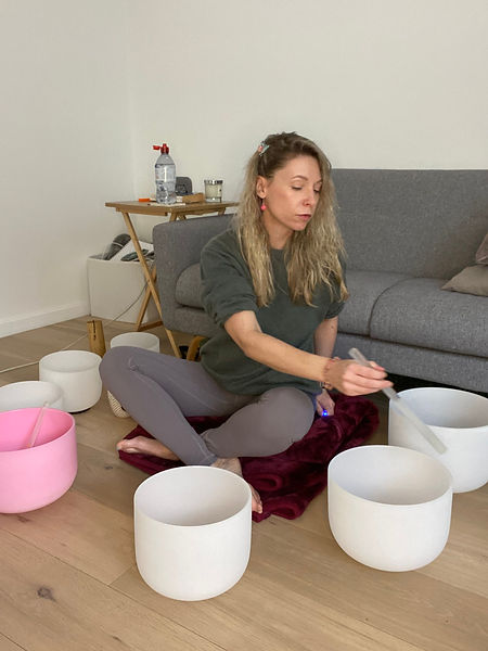 Paula from Full Circle Healing conducting a sound healing session with crystal singing bowls