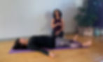 Soma Yoga instructor Karin Weinstein guiding a slow breathing practice for a student lying comfortably on the floor