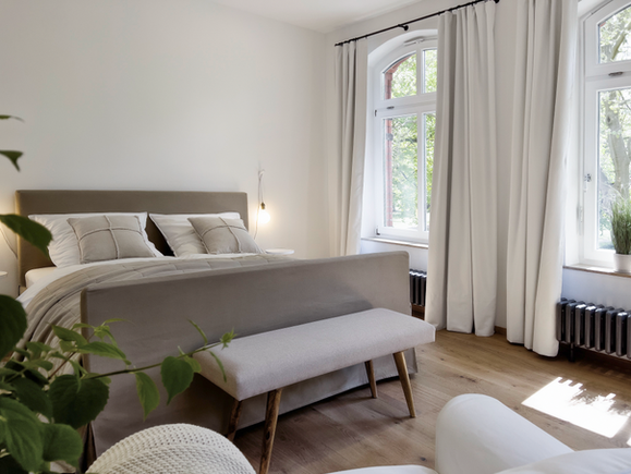 Geräumiges, helles Schlafzimmer mit Doppelbett und Blick auf den Park in der Ferienwohnung Bad Bevensen.