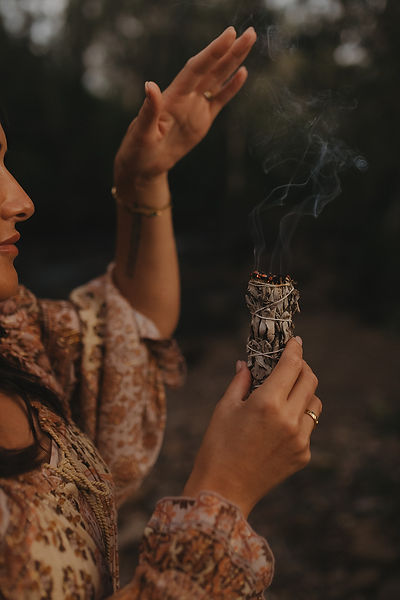 Hands holding burning sage