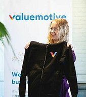 Minka holding a Valuemotive brand hoodie