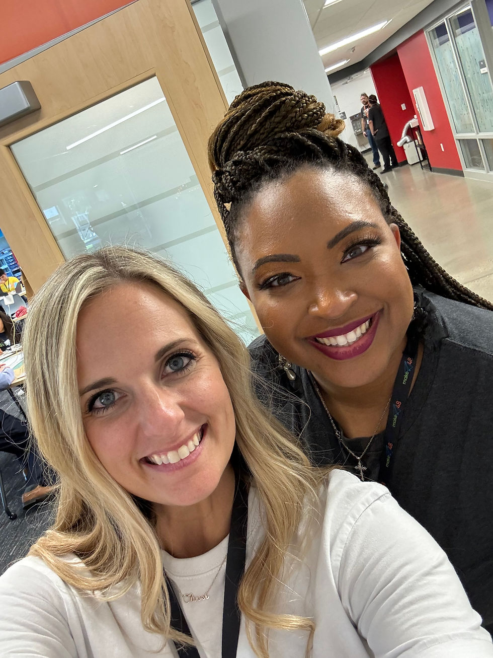 Courtney and Sharrell smiling next to each other