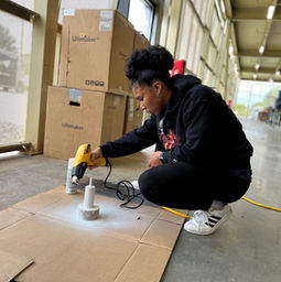 team member using the wagner heat gun to try her prototype
