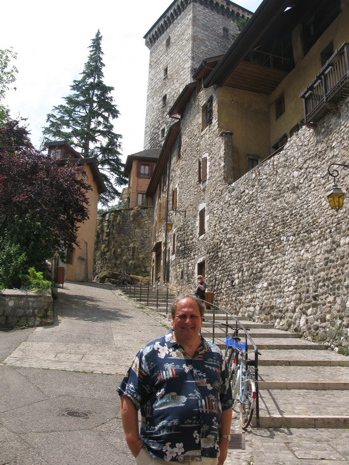 Man standing in front of a stone building.