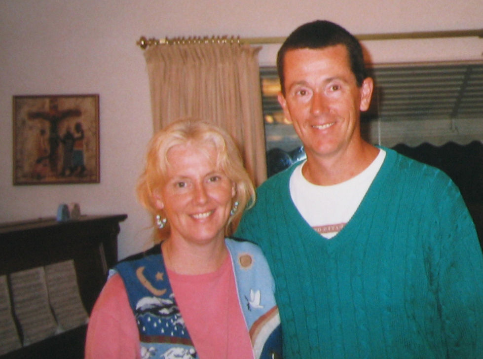 A smiling couple posing indoors.