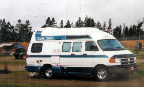 White camper van labeled "Classic 2000" parked outdoors.