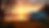 Eye-level view of a motorhome parked beside a serene lake at sunset