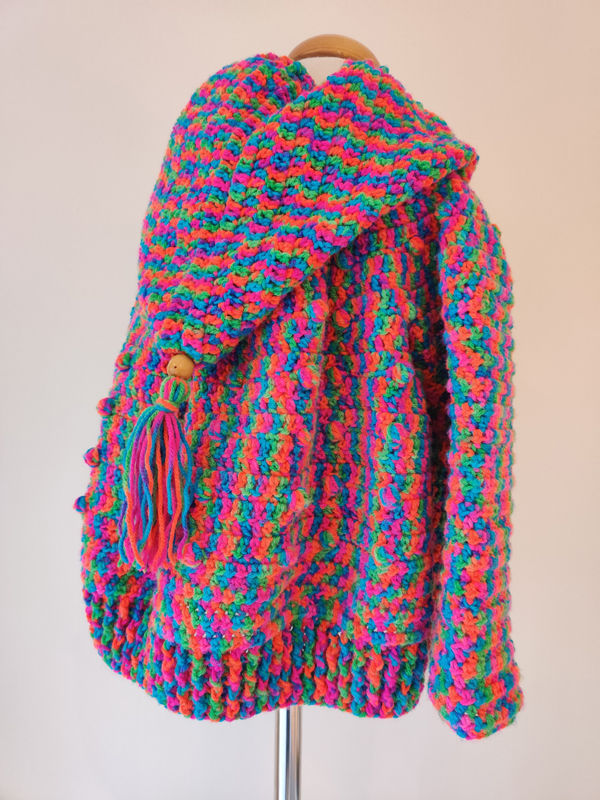 Miniatyrbild: girl's hooded jacket in multi coloured crocheted wool by SerendipityGDDs uploaded by KHWD