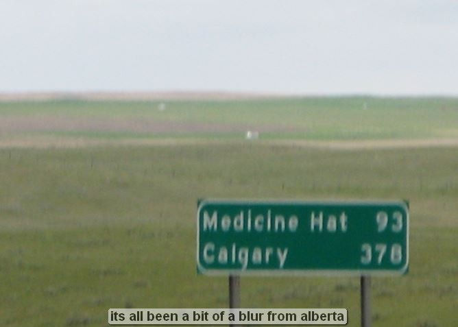 Green road sign in Alberta, Canada landscape.