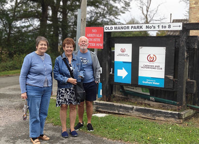 3 friends standing outside grafham water camp site entrance
