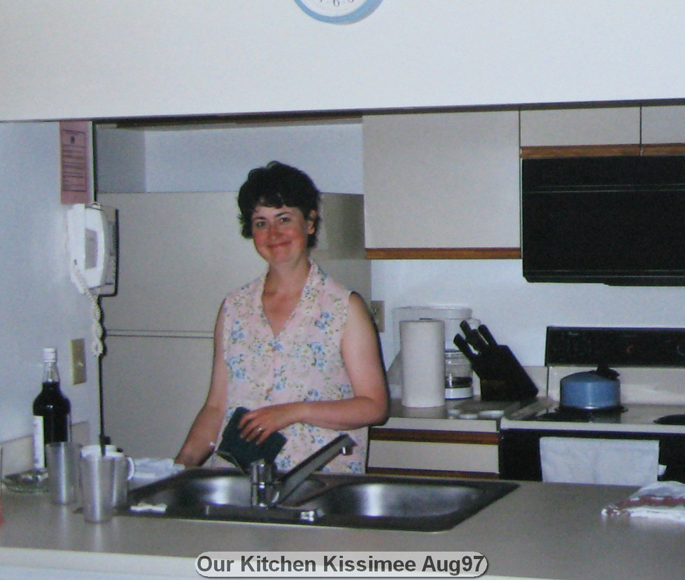 Woman in kitchen, labeled "Our Kitchen Kissimmee Aug97".