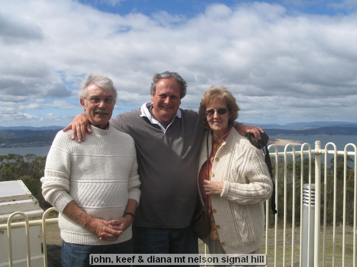 Three people posing at a scenic viewpoint.