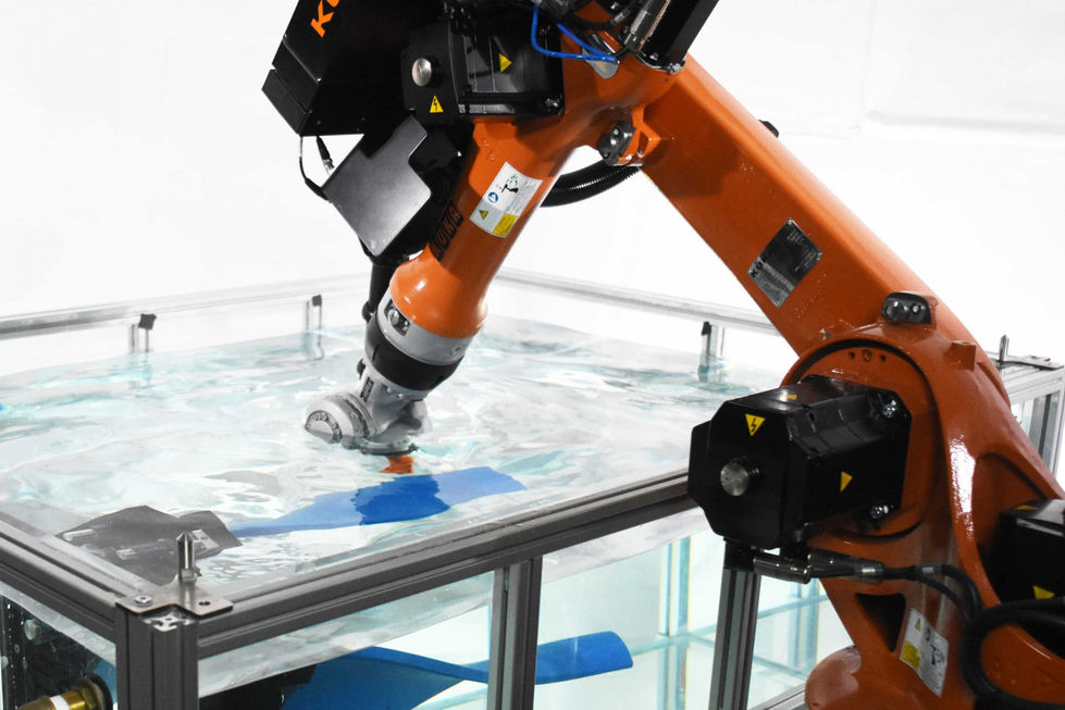Robotic arm working in a water-filled tank.