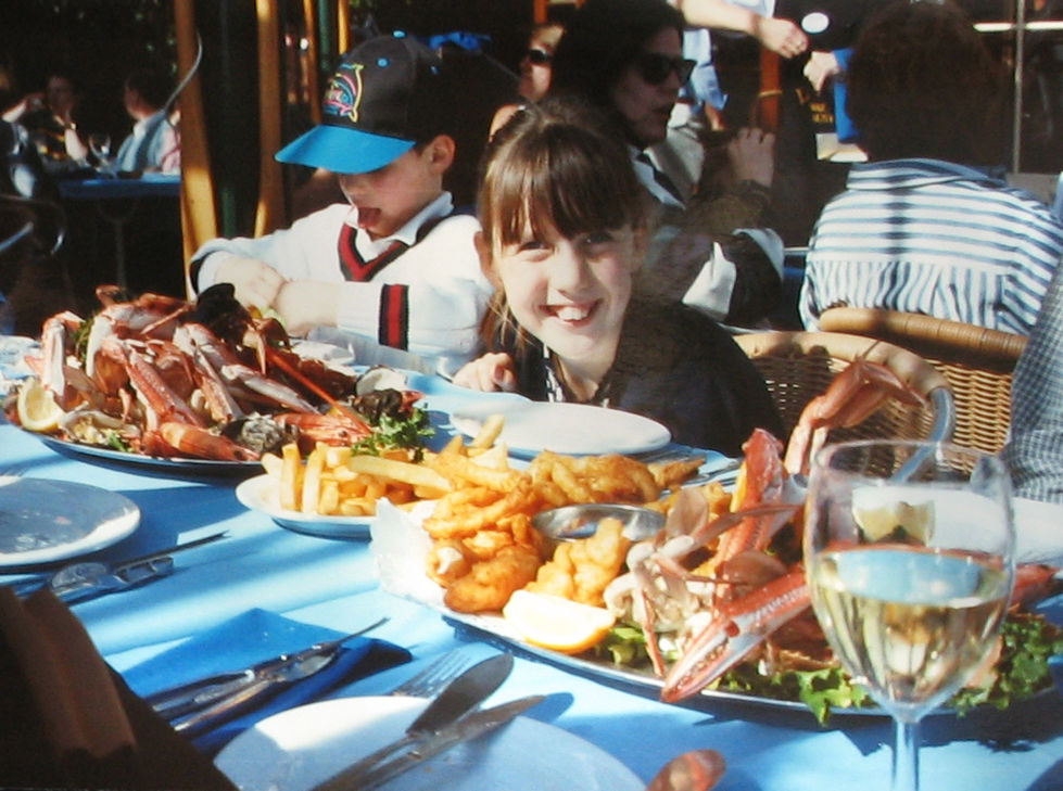 Children enjoying a seafood meal at a restaurant.