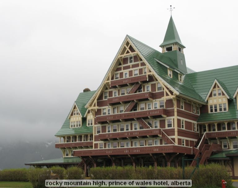 Large, rustic hotel with green roof in Alberta.
