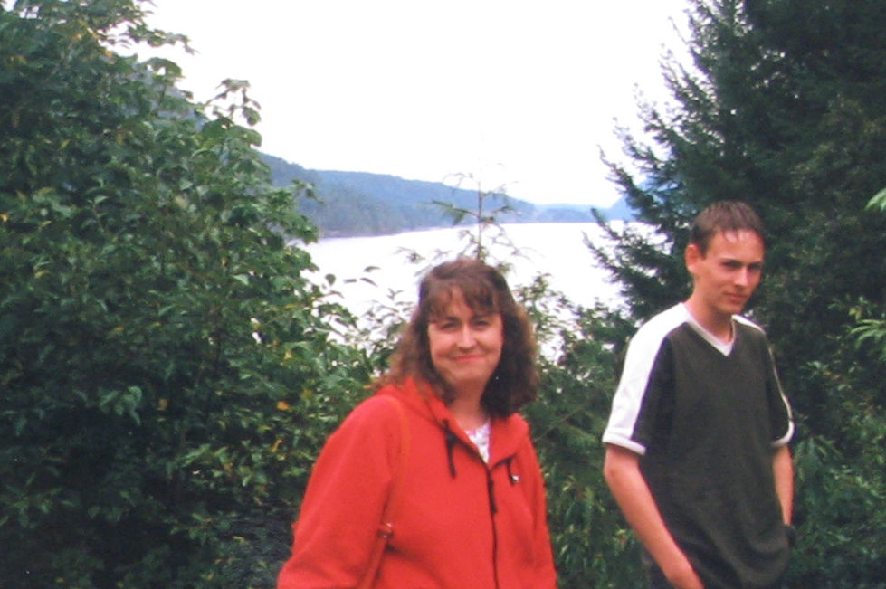 A woman in a red jacket outdoors.