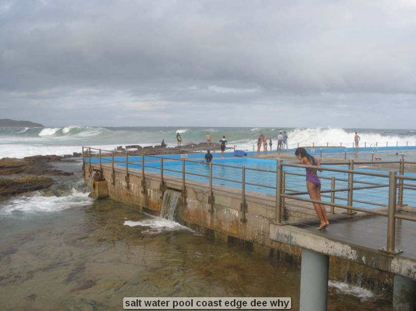 People at ocean pool on a cloudy day.