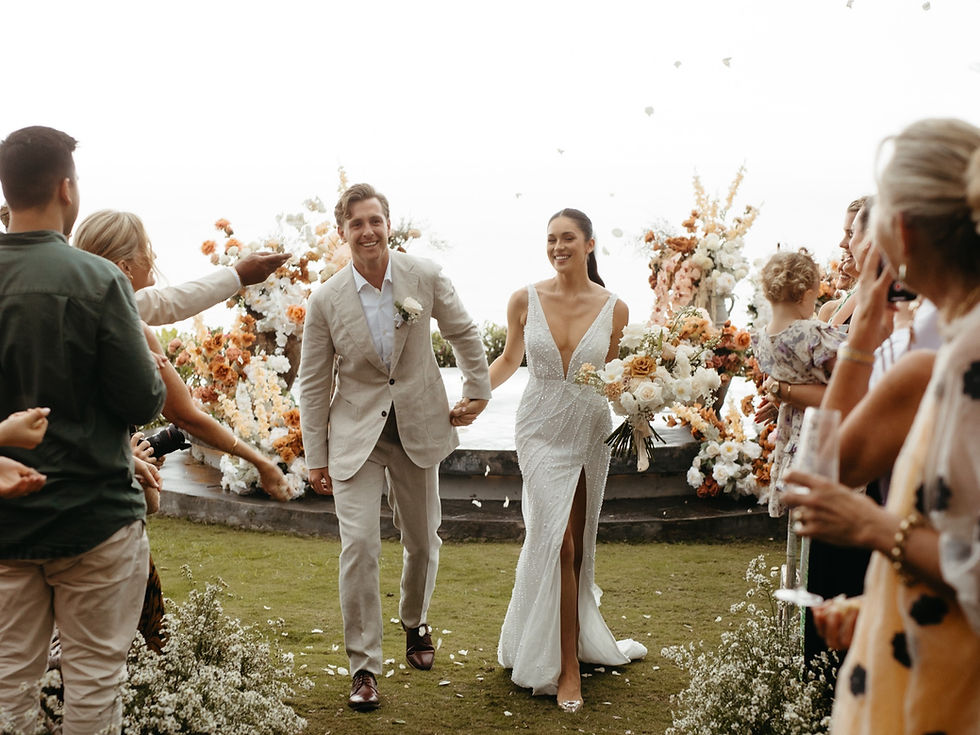 Bride & groom walking at the altar, holding a bouquet of flowers.