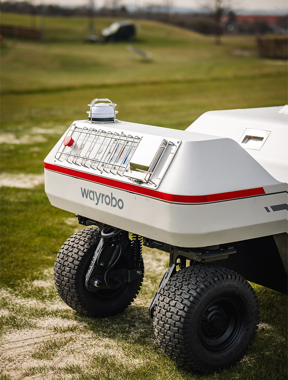 Autonomous golf ball picker navigating range turf during daily operation