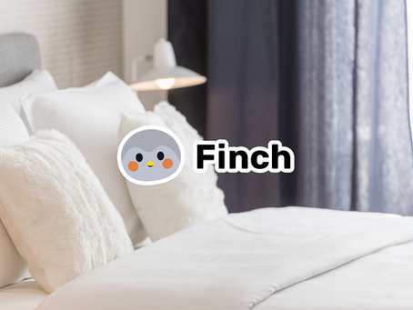 Comfortable bed with the Finch App logo in the centre, illustrating how better sleep supports self-care and overall wellbeing.